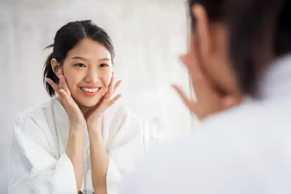 photo of woman looking in mirror